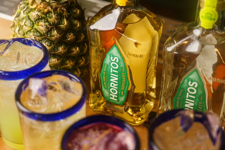 hornitos tequila and mixed drinks with pineapple on bar