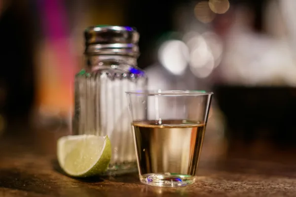 tequila in shot glass with salt and lime