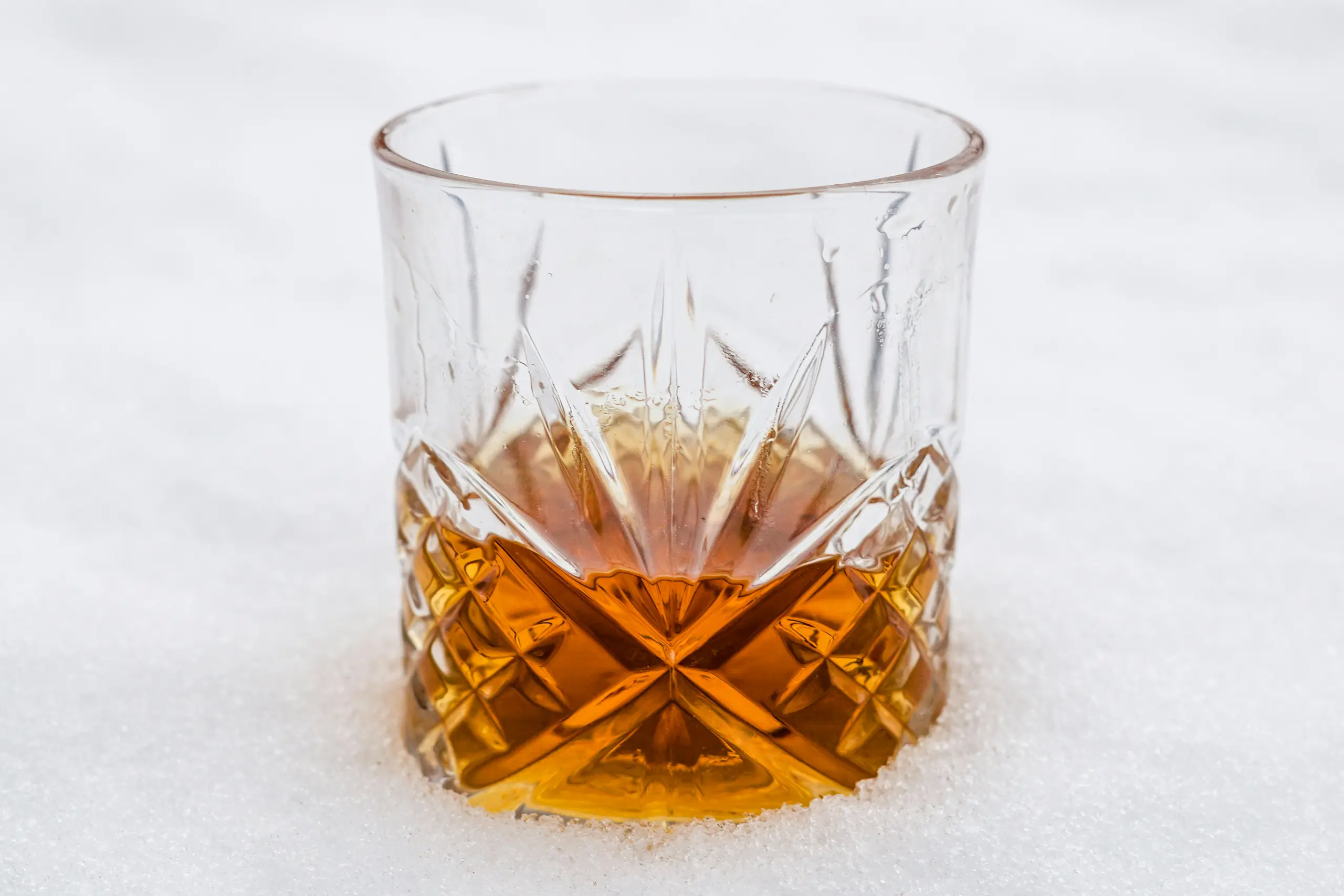 whiskey in a glass in the snow